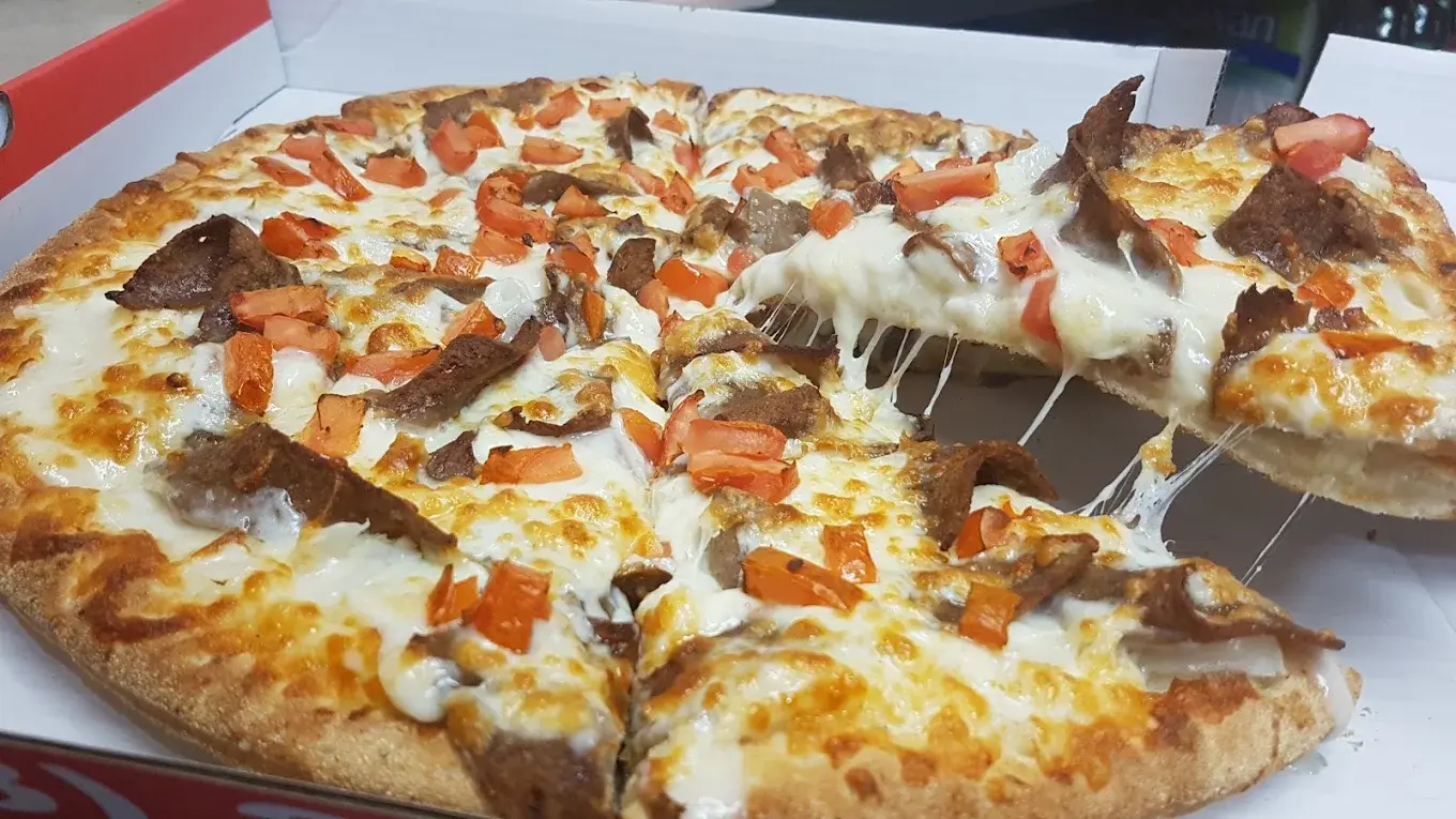 Deluxe combination pizza with house-made sauce at Pizza 3000 Bowness